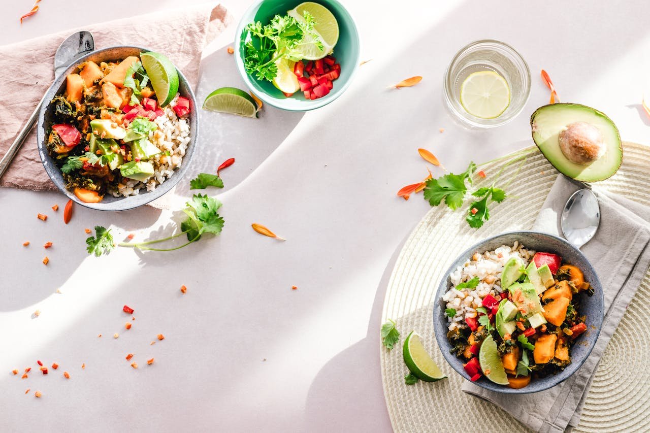 heros-img Top-down view of vibrant vegan bowls filled with fresh vegetables, perfect for a healthy meal.